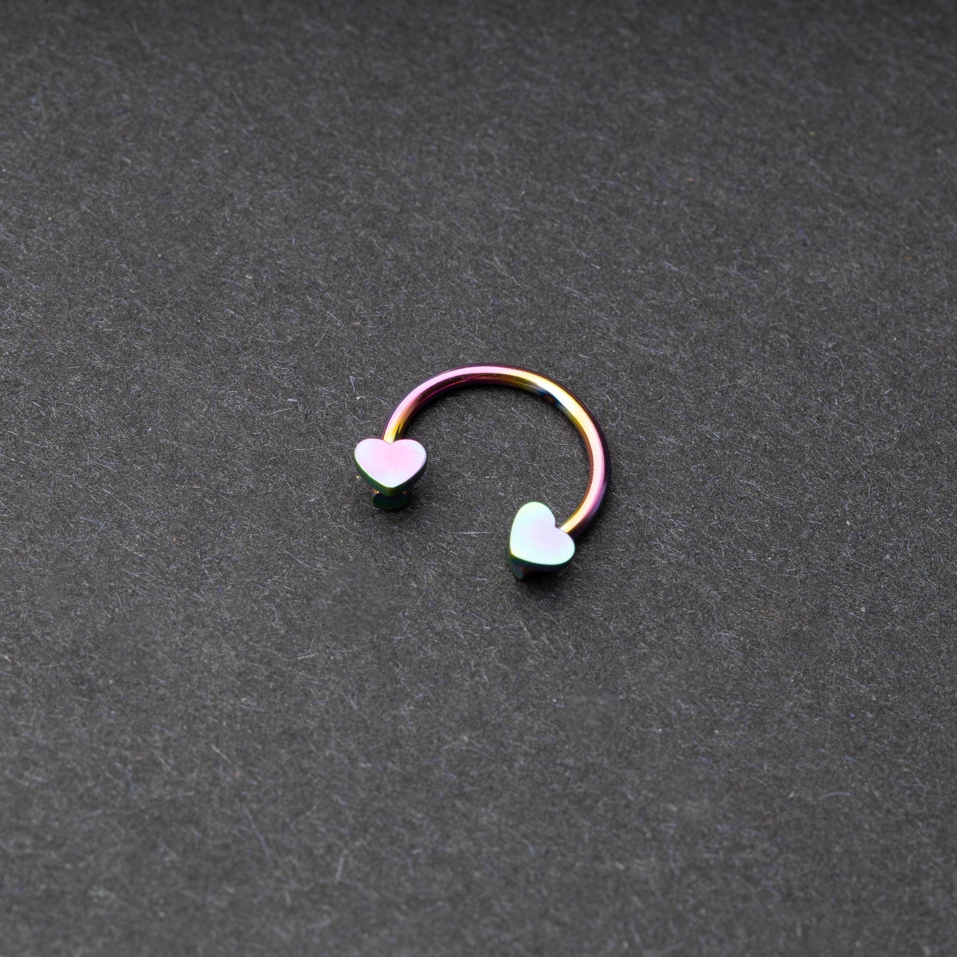 Rainbow Horsehoe hoop with heart ends in silver. 