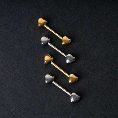 Heart-shaped silver and gold barbells on a dark background.