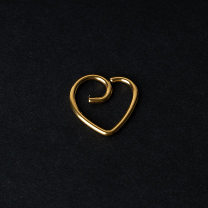 Gold heart shaped daith on a dark background