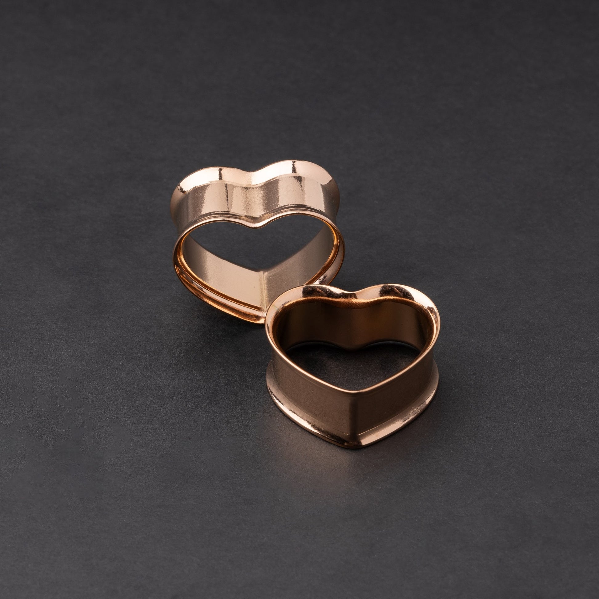 Heart-shaped tunnels in rainbow, displayed on a dark background.
