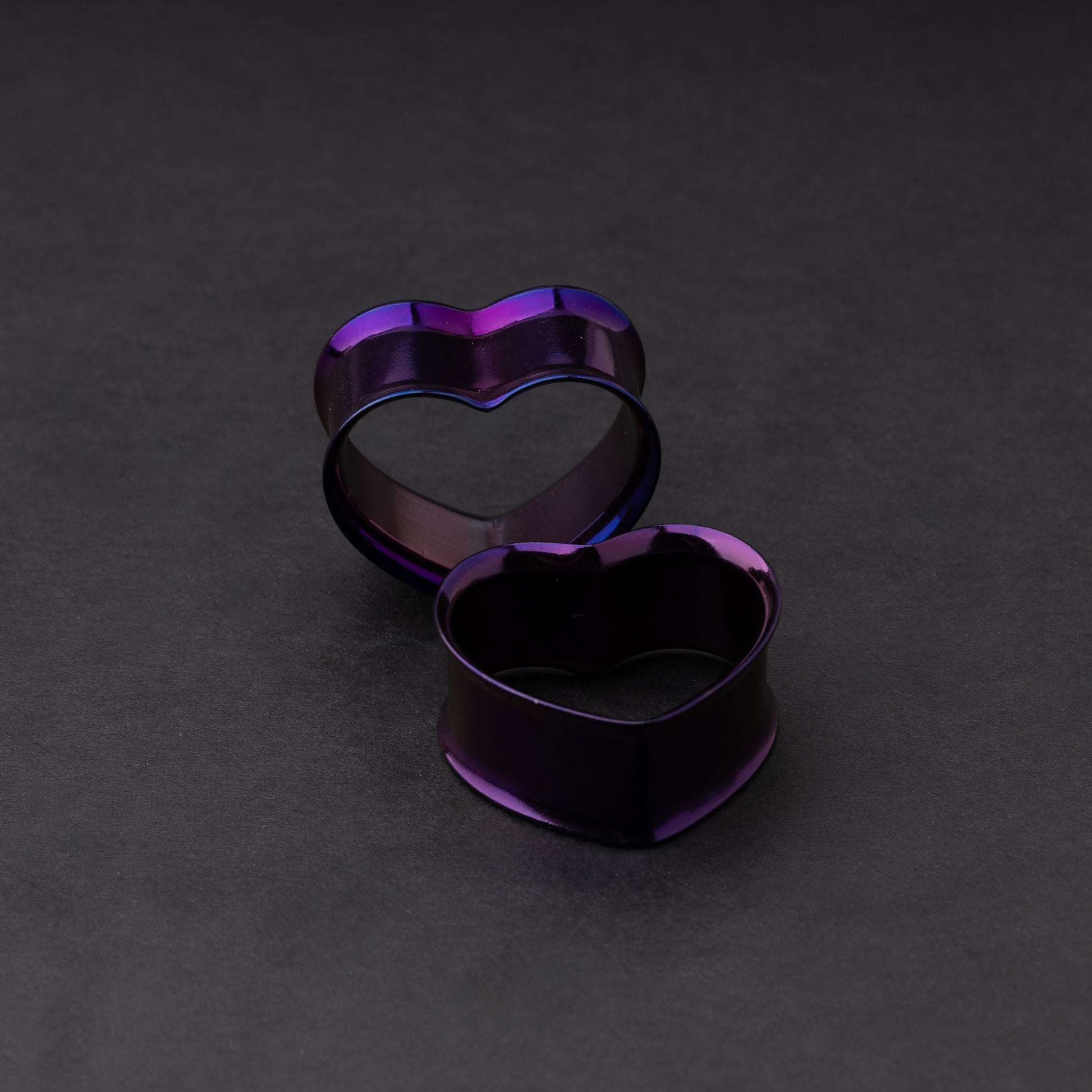 Heart-shaped tunnels in purple, displayed on a dark background.