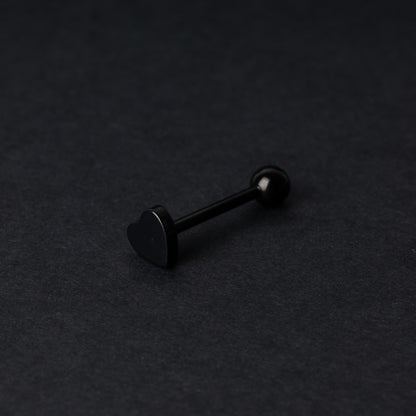 Heart shaped tongue bar in black, displayed on a dark background.
