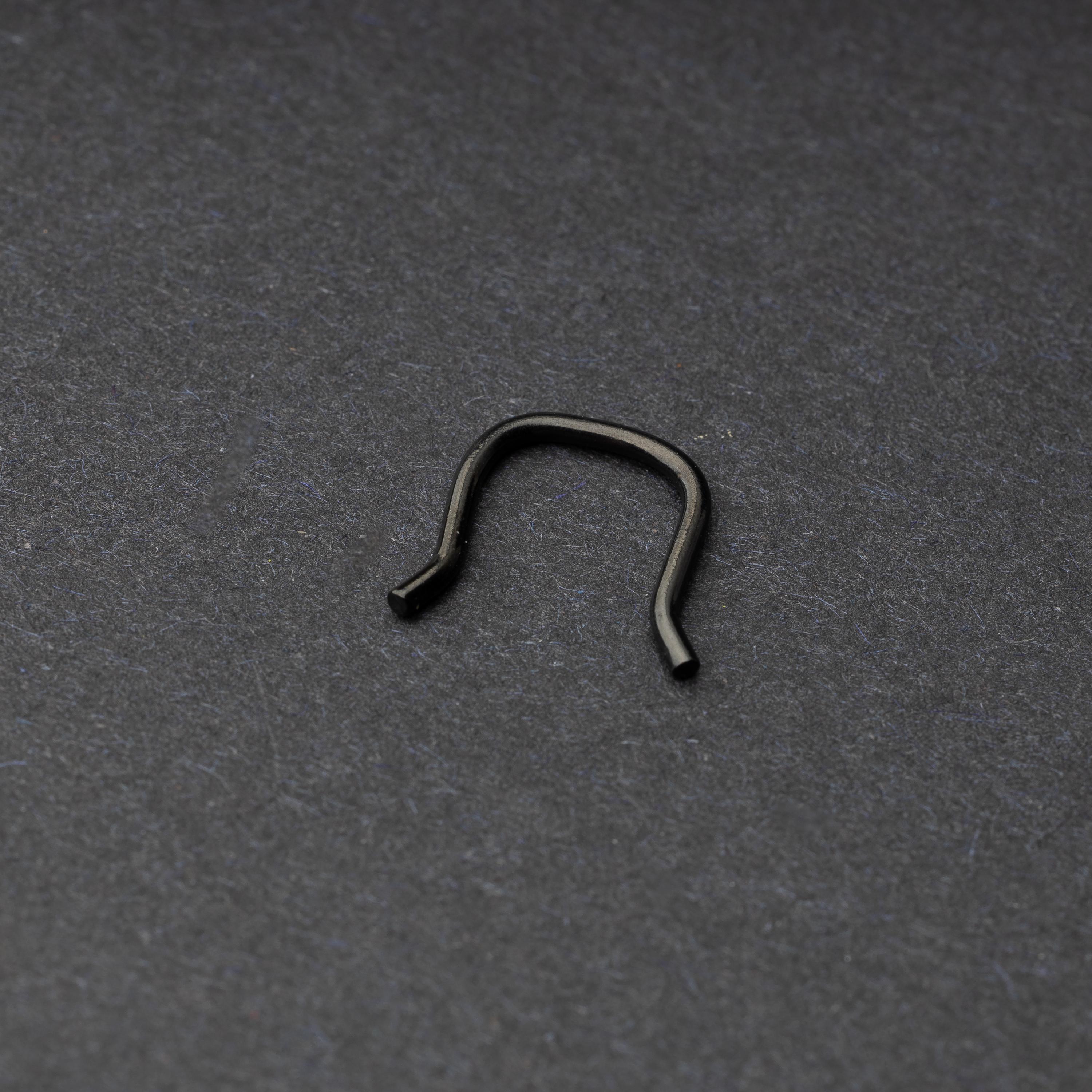 U-shaped septum retainer in black displayed on a dark background