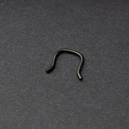 U-shaped septum retainer in black displayed on a dark background