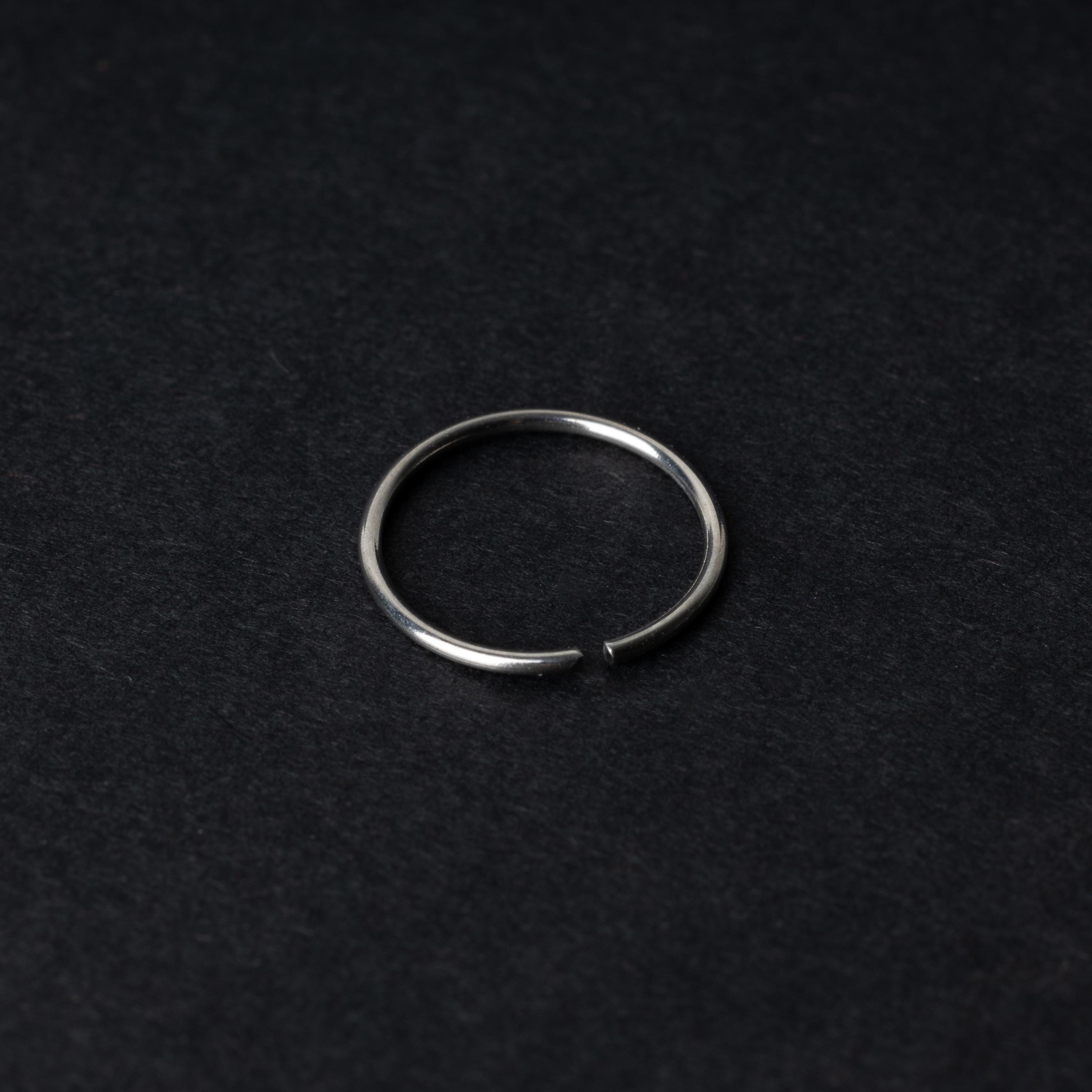 A single thin silver seamless hoop with a polished finish, displayed on a dark background.