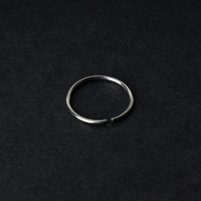 A single thin silver seamless hoop with a polished finish, displayed on a dark background.