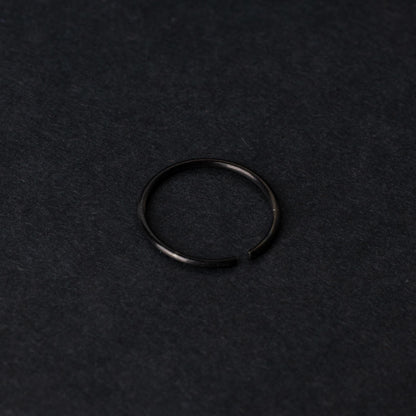A single thin black seamless hoop with a polished finish, displayed on a dark background.