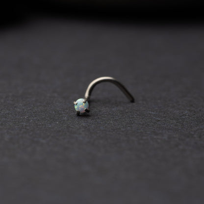 Single opalescent nose screw with a prong setting, displayed on a dark background.