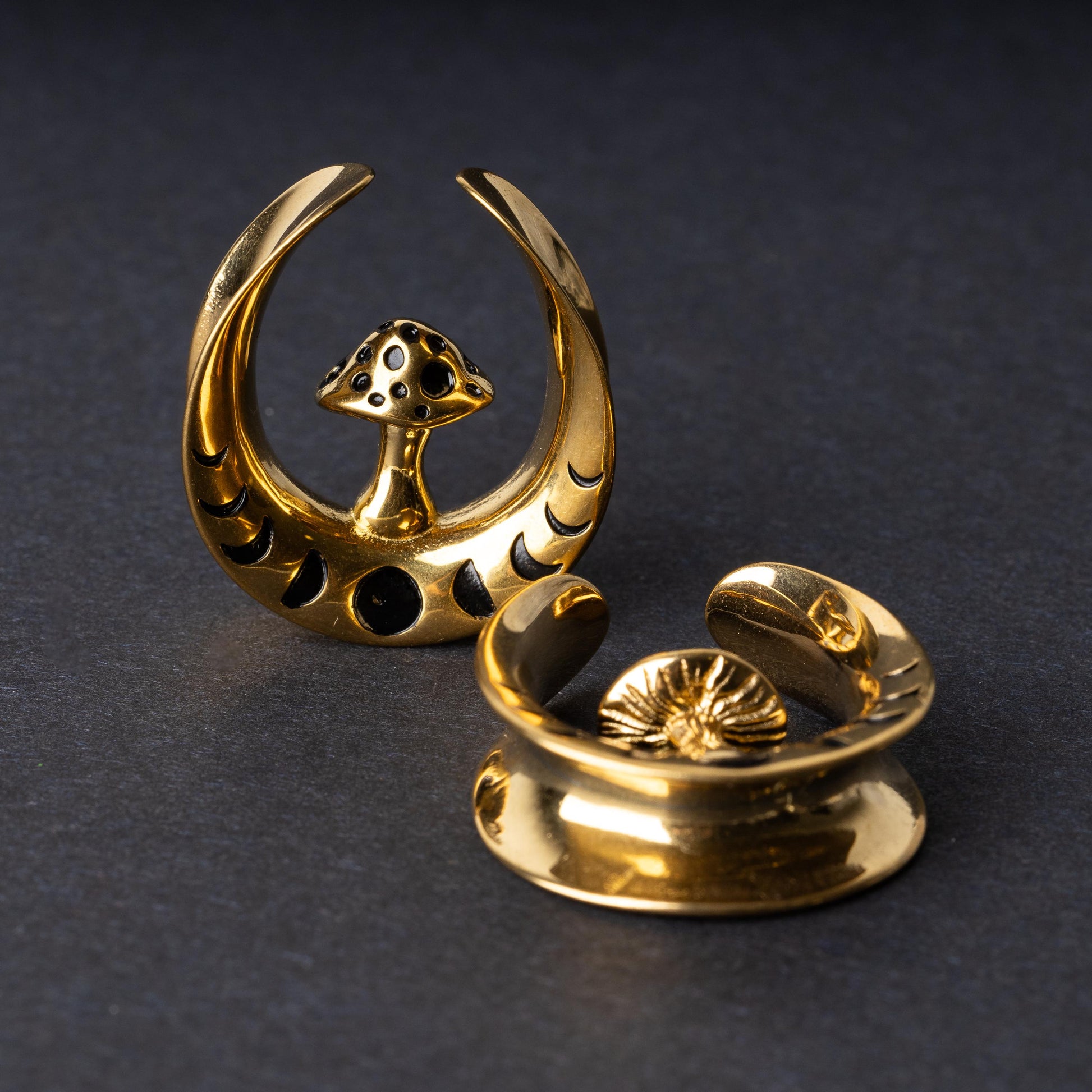 Pair of crescent moon tunnels with mushroom detailing in Gold, displayed on a dark background.