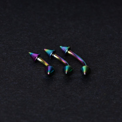 Three rainbow titanium curved barbells with cone-shaped ends, displayed on a dark textured background, showcasing their vivid color gradient and sleek design.