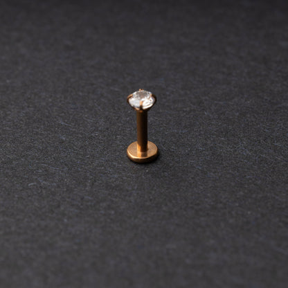 Rose Gold Labret bar on a dark background