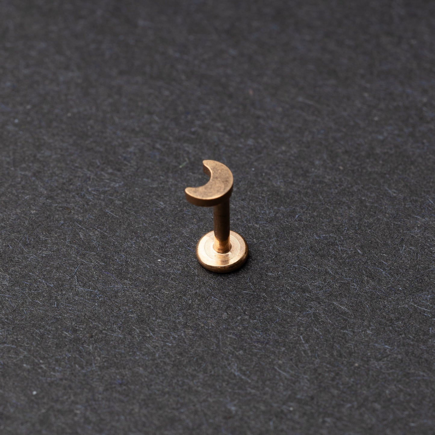 Moon flat back bar in rose gold displayed on a dark background