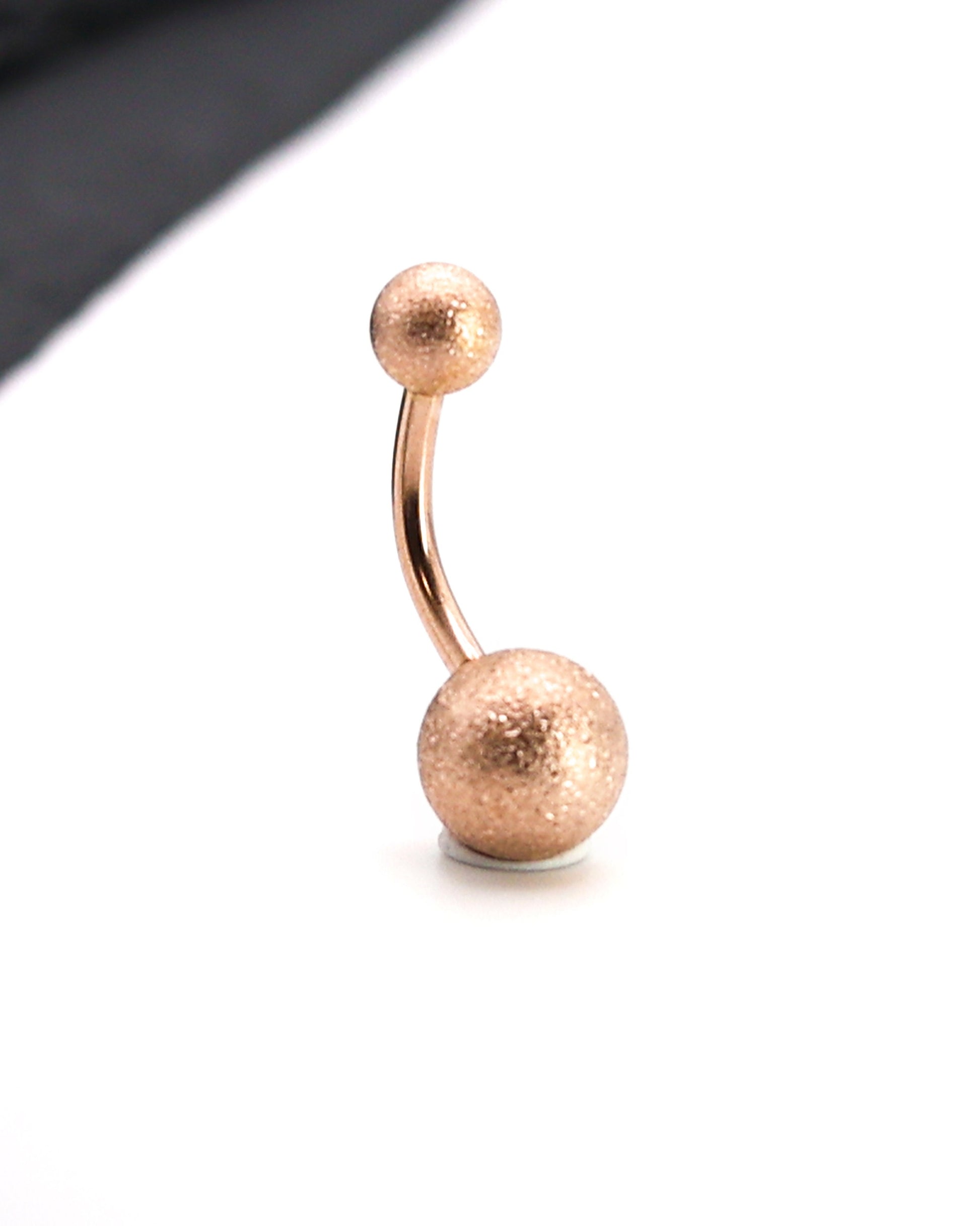 Rose Gold Shimmery Belly Button Bar, displayed on a white matte background.