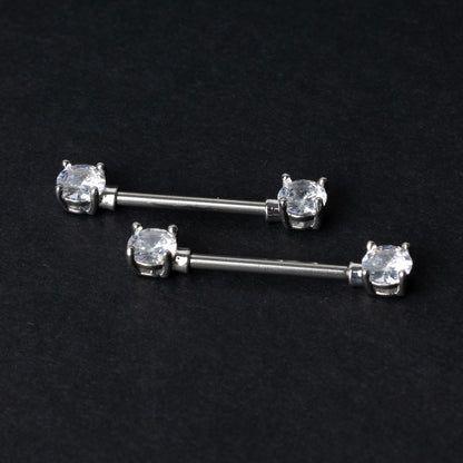 Crystal-studded barbells in silver displayed on a dark background.