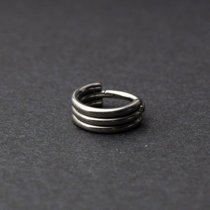 Triple-band seamless hoop rings in a silver finish displayed on a dark background, highlighting their sleek and modern design.