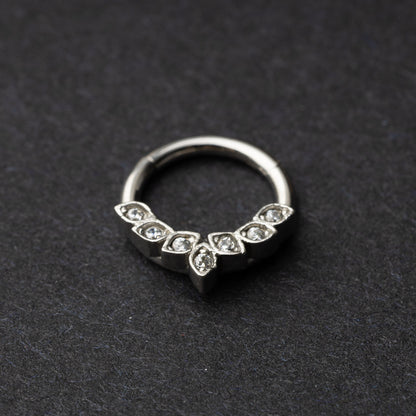 Marquise gemstone stainless steel clicker in silver displayed on a dark textured background.