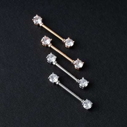 Four Crystal-studded barbells in rose gold and silver finishes, displayed on a dark background.