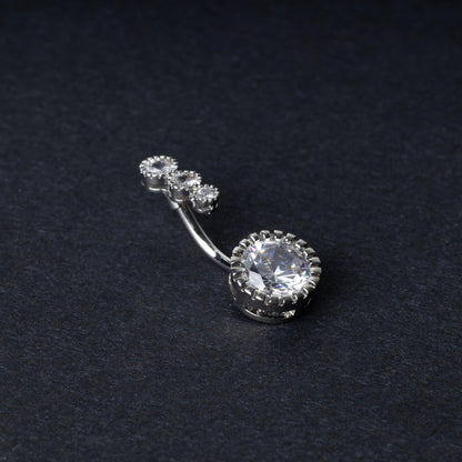 Double-jeweled belly rings in silver with large and small crystal accents, displayed on a dark background.