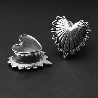 Sacred Heart plugs in gold and silver finishes, showcasing intricate 3D heart designs with a radiant pattern, displayed on a matte dark background.