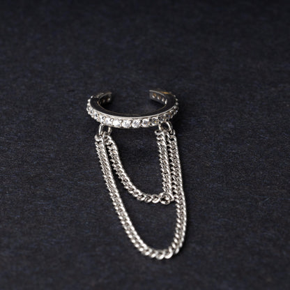 Septum clicker with double chains and gem-encrusted arc, in silver shown on a dark background.