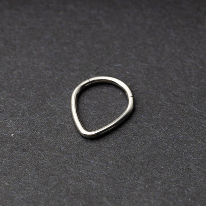 Silver Teardrop Clicker displayed on a dark background