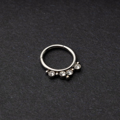 A stainless steel clicker with clear gemstones and bead accents, suitable for septum or daith piercings.