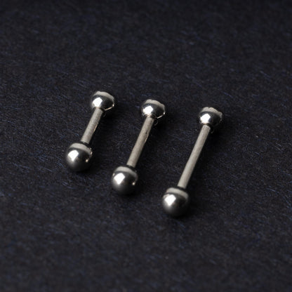 Stainless steel barbells on a dark background.