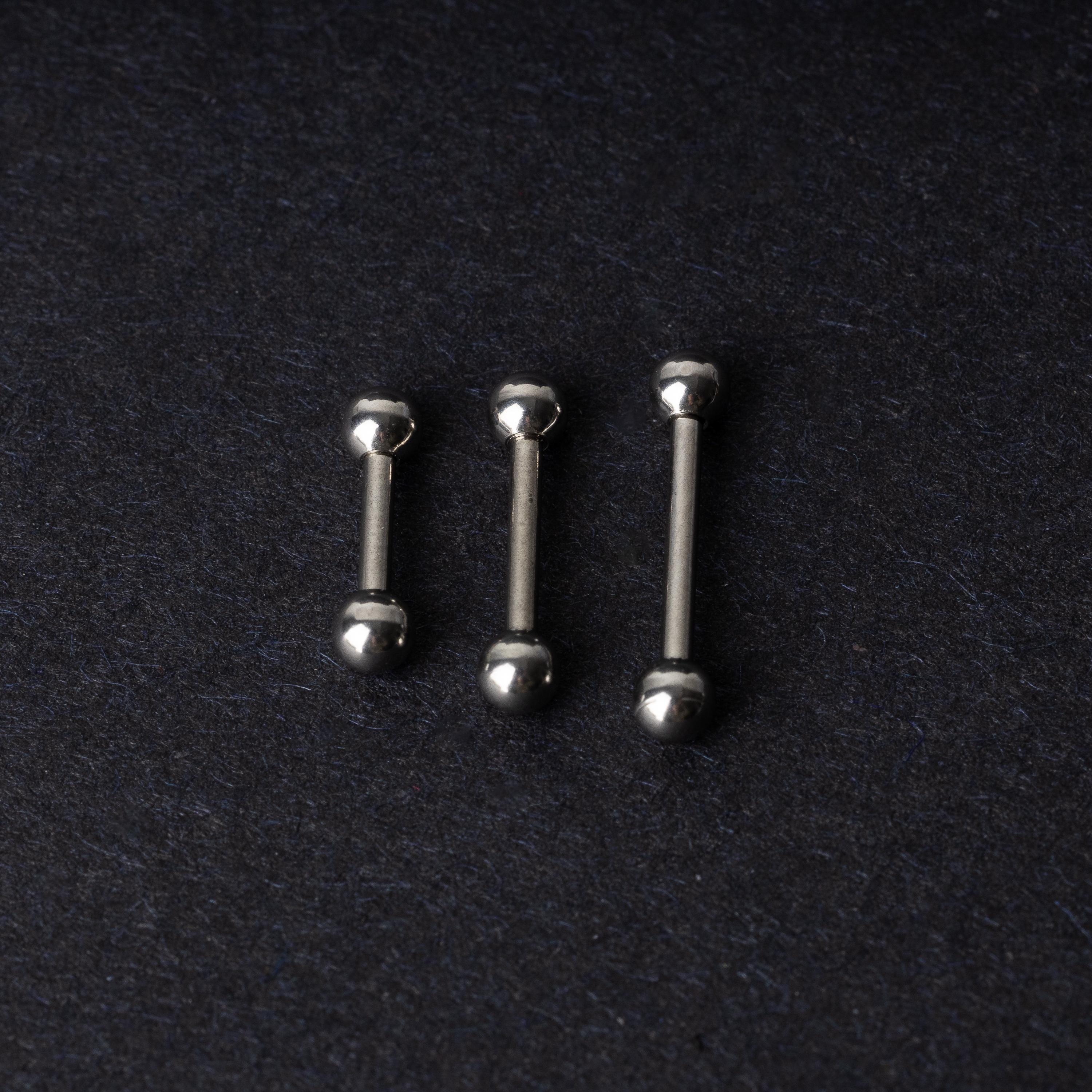 Stainless steel barbells on a dark background.