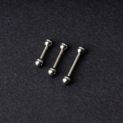 Stainless steel barbells on a dark background.