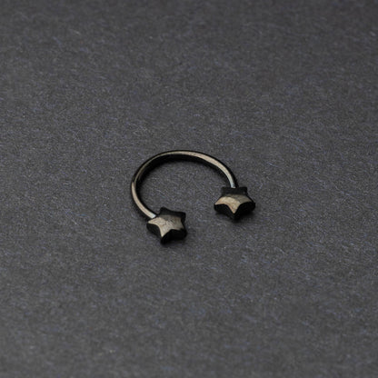 Stainless steel horseshoe hoop with star-shaped ends in black, displayed on a dark background.