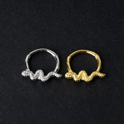 Silver and gold snake motif hinged rings crafted from 925 Sterling Silver on a dark background.
