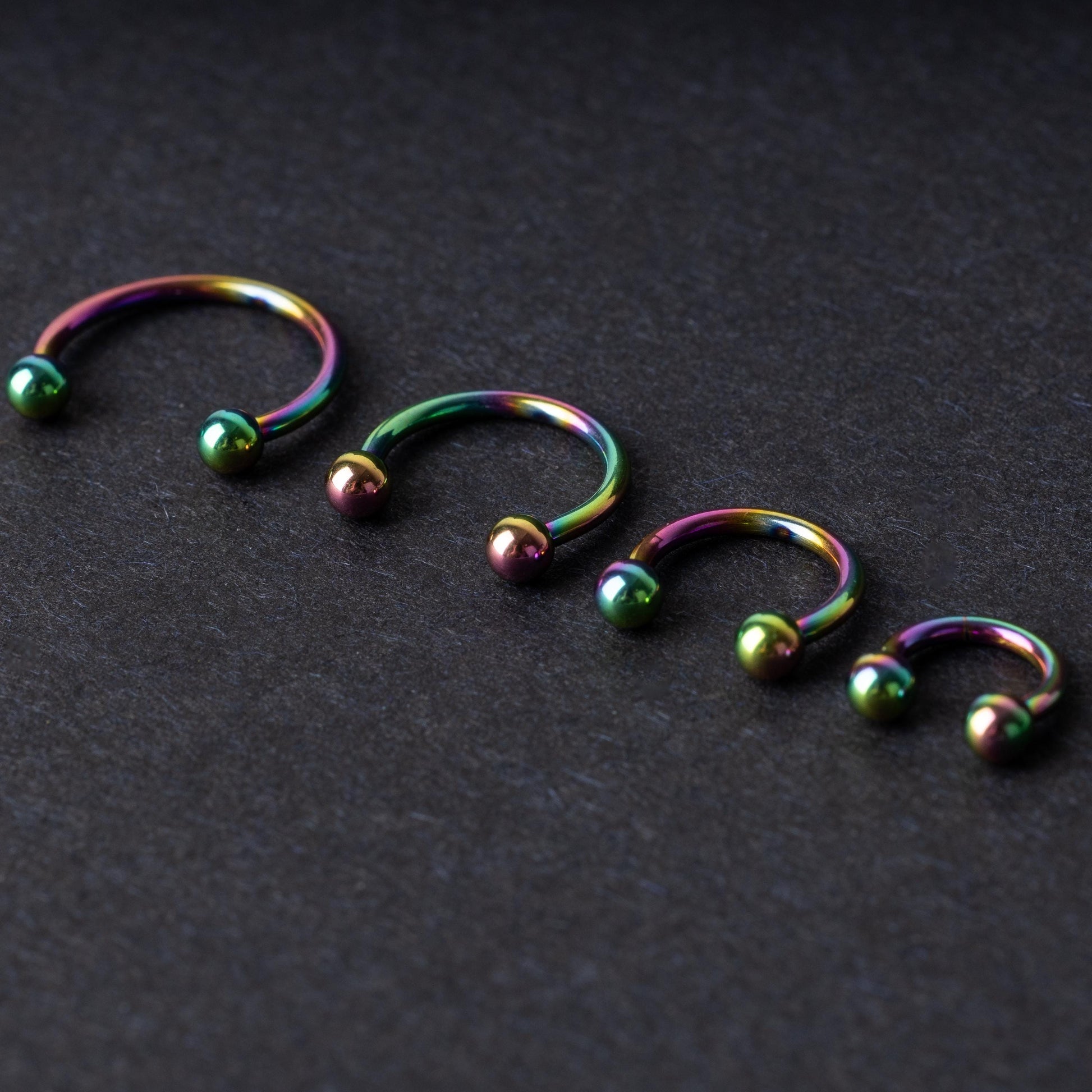 Titanium Rainbow Horseshoe Hoops in Rainbow on a dark background