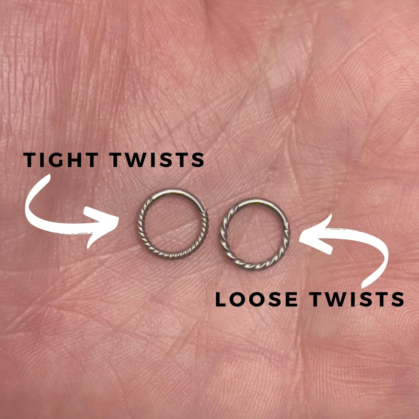 Two twisted clicker rings displayed on a hand with annotations detailing the difference between loose and tight twists. 