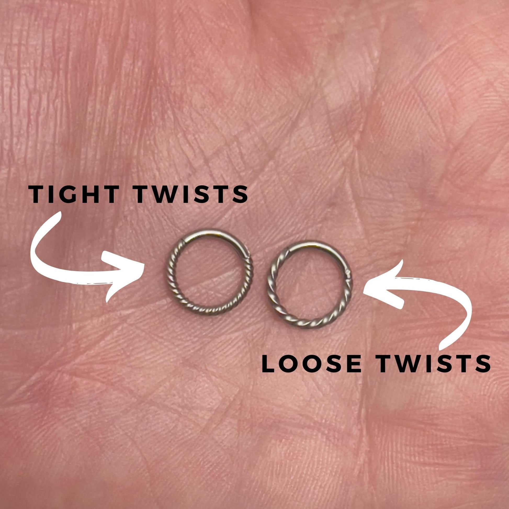 Two twisted clicker rings displayed on a hand with annotations detailing the difference between loose and tight twists. 